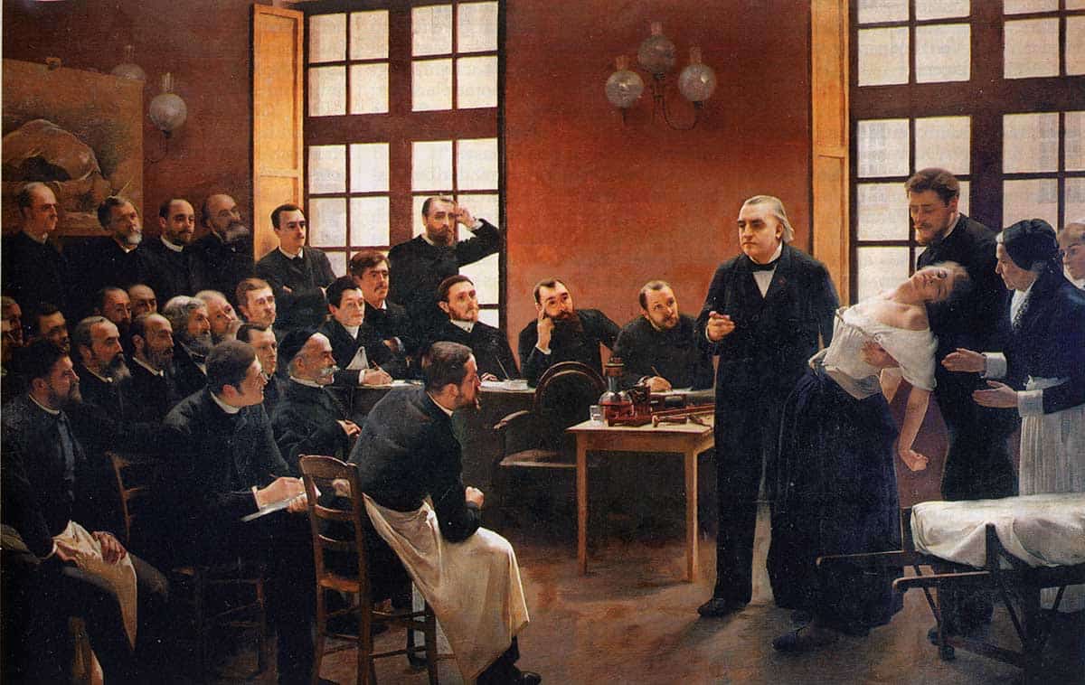 A Clinical Lesson at the Salpêtrière by André Brouillet in 1887. Source: Wikimedia Commons