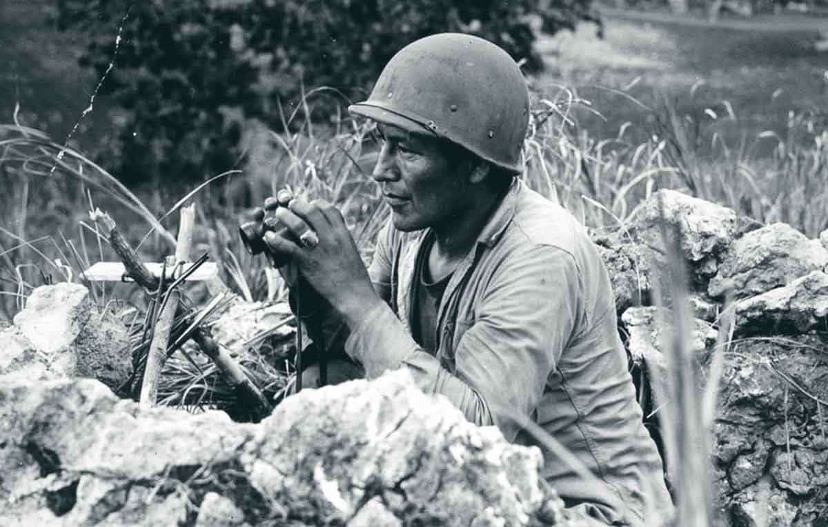 Carl Nelson Gorman, one of the original 29 Navajo code talkers, tracks enemy movements on Saipan. 1944. Source: Rare Historical Photos