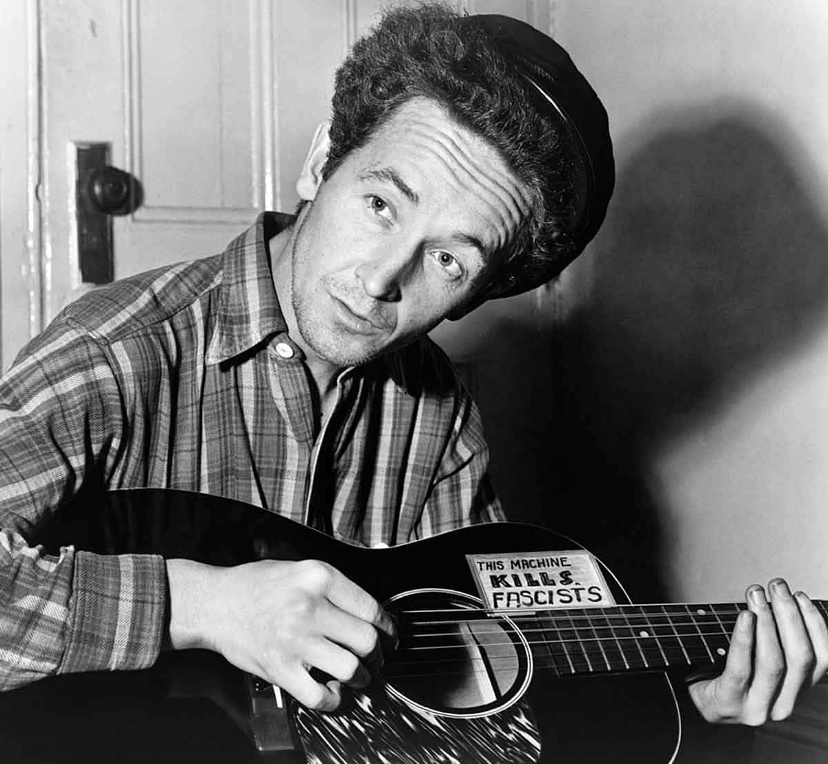 This Machine Kills Fascists, Woody Guthrie pictured in 1943, Source: Wikimedia Commons