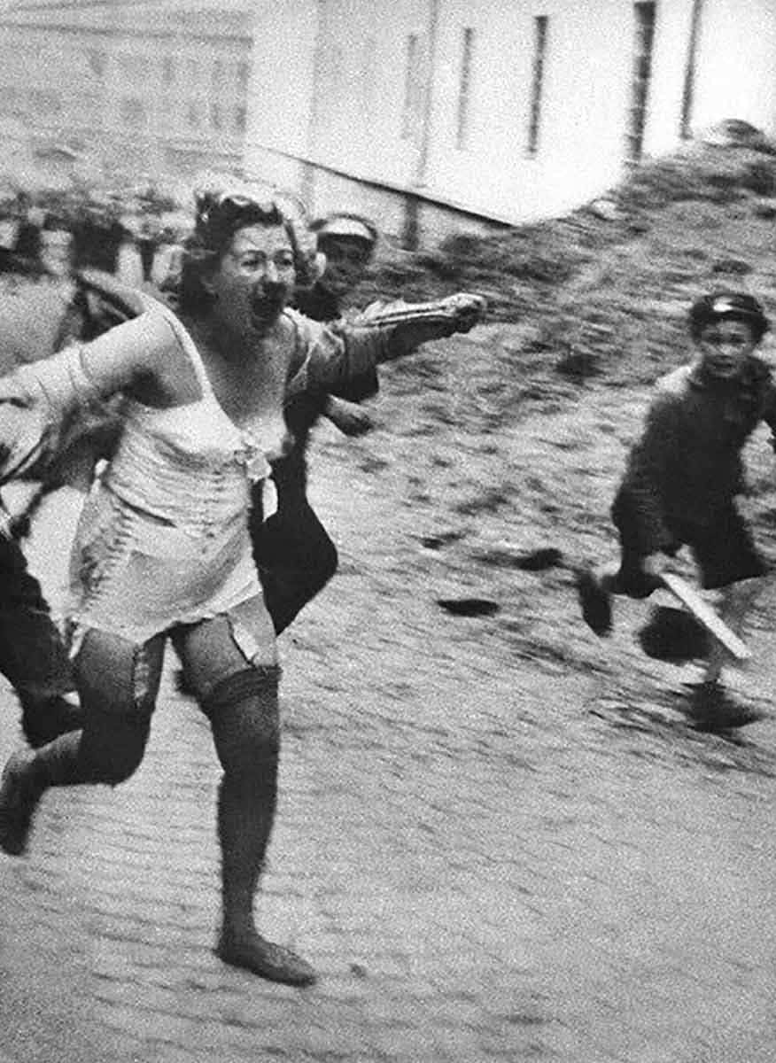 woman fleeing mob