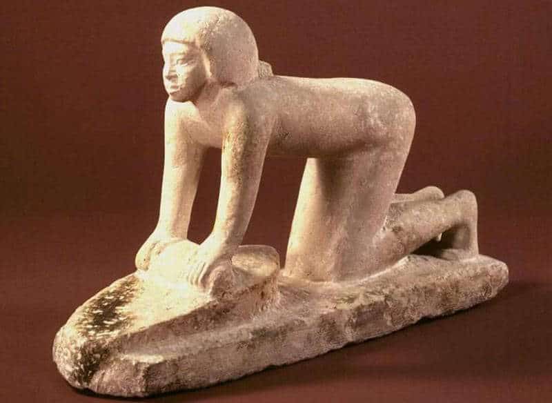 Statuette of a woman grinding grain, via Global Egyptian Museum